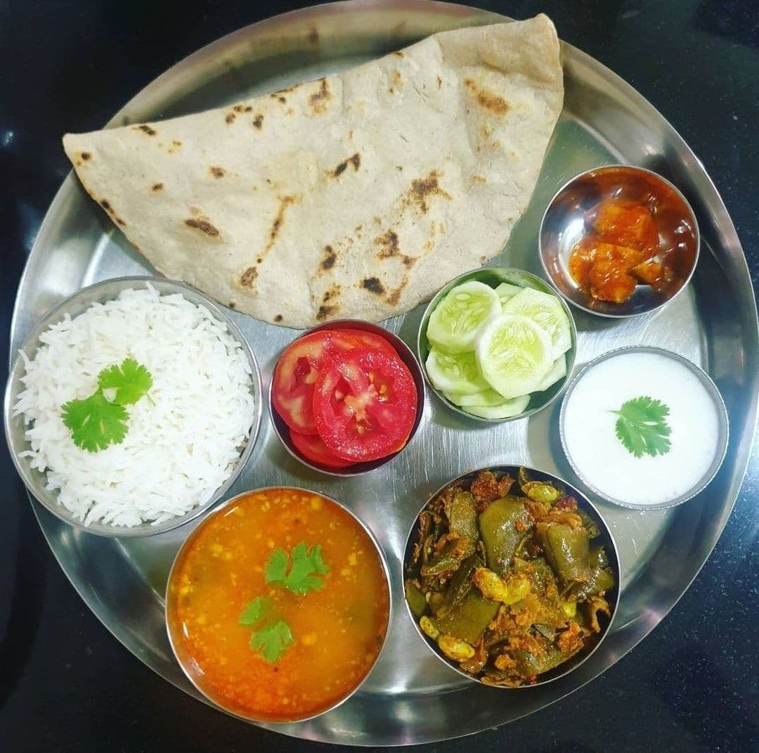 Traditional North Karnataka thali with rice, dal, vegetables, and roti